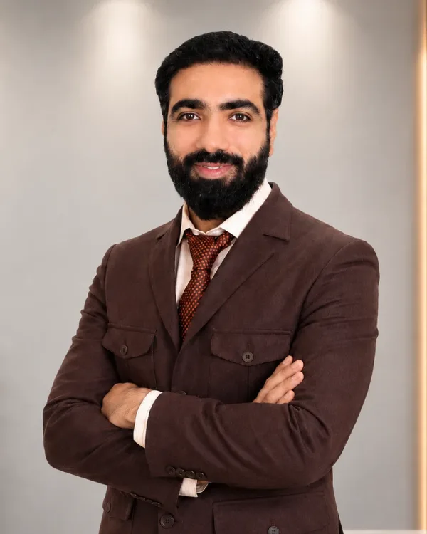 Chirag Kalra, founder of WealthPillar, standing in the office with his arms crossed