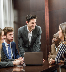 A small team meeting around a laptop